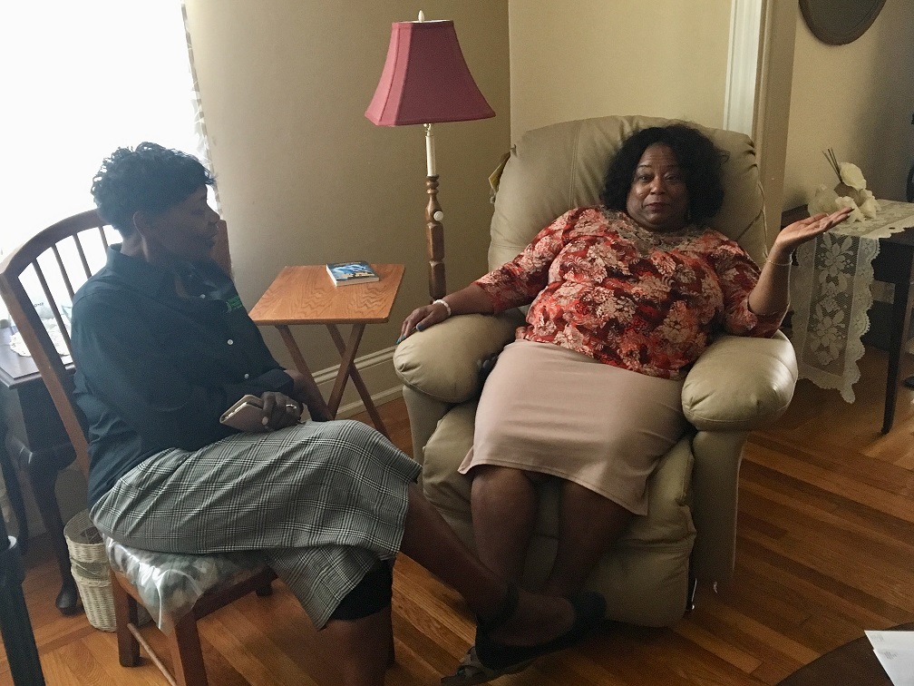 Two women sitting in a living room talking