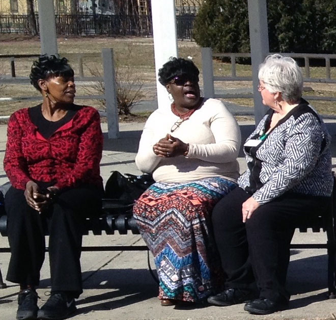 Three women sitting on a bench