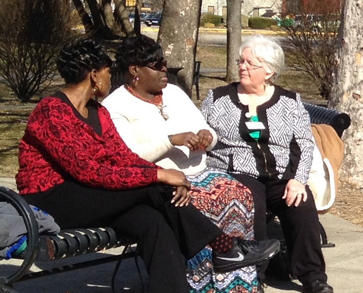 Three women sitting on a bench
