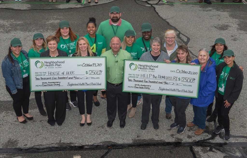 Employees posing with checks for House of Hope and Help the Homeless RI